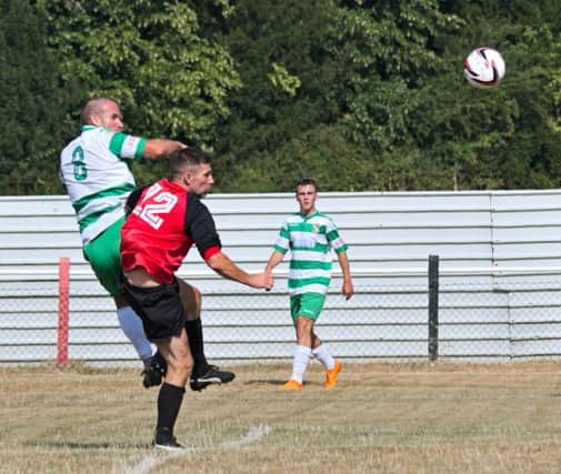 Greg Williams heads United level during Saturday's friendly with Tring Athletic. Picture: Mike Snell