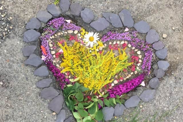 A pothole in Chearsley was decorated by three village youngsters last week