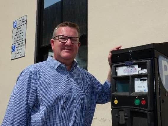 Cllr Mark Shaw with a parking ticket machine