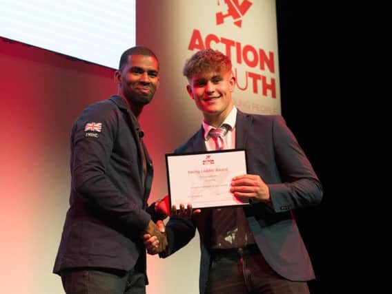 Alistair Patrick-Heselton, GB seven-a-side footballer, presents a Young Leader award to Kyle Cummins