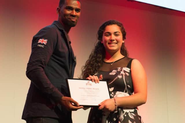 GB Paralympic footballer Alistair Patrick-Heselton presents a Young Leader awards to Isabella Cirigottis