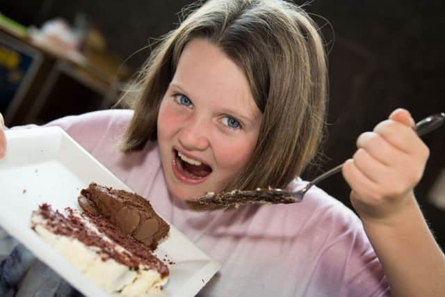 Aylesbury estate agents and solicitors bake off for Florence Nightingale Hospice, at Aylesbury Waterside Theatre - pictured sampling some chocolate cake is Evie Shanahan (11)