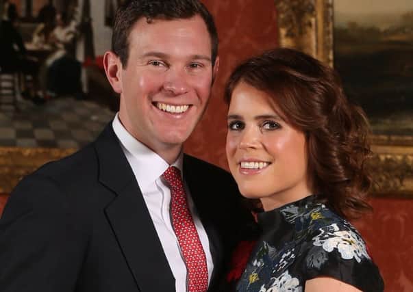 ALTERNATE CROPPrincess Eugenie and Jack Brooksbank in the Picture Gallery at Buckingham Palace in London after they announced their engagement. Princess Eugenie wears a dress by Erdem, shoes by Jimmy Choo and a ring containing a padparadscha sapphire surrounded by diamonds.  PRESS ASSOCIATION Photo. Picture date: Monday January 22, 2018.  They are to marry at St GeorgeÃs Chapel in Windsor Castle in the autumn this year. See PA story ROYAL Eugenie. Photo credit should read: Jonathan Brady/PA Wire PPP-180123-095819001