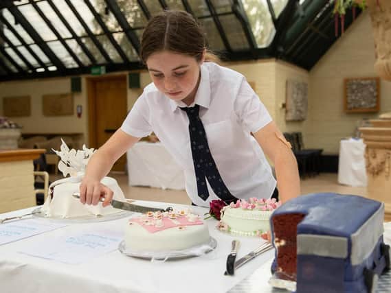 A student samples a cake at the Waddesdon bake off event