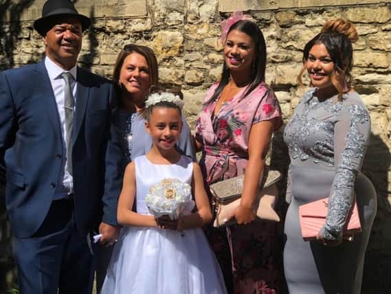 The Pinnock family - second from left is Kim with her husband Houghton left, her daughters Jade (pink dress) and Amber to her right and her grand-daughter Sienna at the front