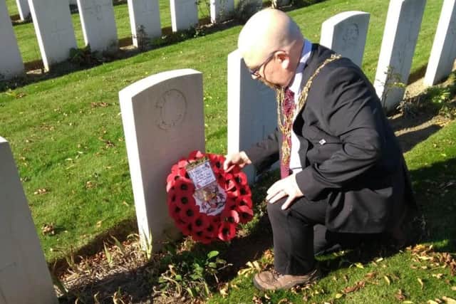 Aylesbury mayor Cllr Mark Willis lays a wreath at the grave of an Aylesbury soldier who lost his life in Belgium at the age of 29