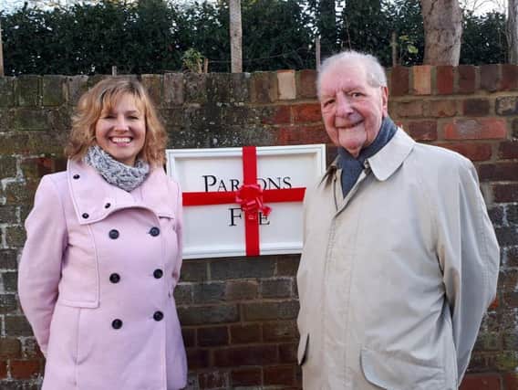Diana Fawcett, Aylesbury town centre manager, alongside David Vowles from the Aylesbury Old Town Residents Association - they are pictured next to one of the newly-installed signs