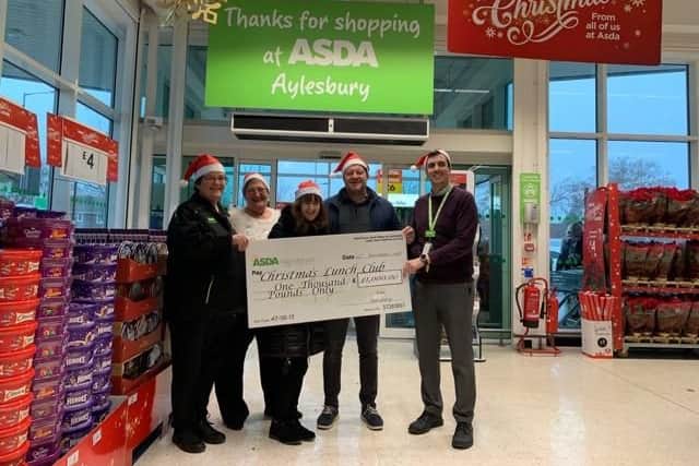 Angie Young, ASDA community champion presents a cheque to Kim and Paul Walter, organisers of Aylesbury's community Christmas lunch