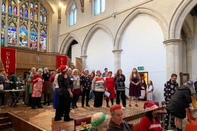 Rock choir members performing as part of the Christmas Day lunch at St Mary's Church, Aylesbury