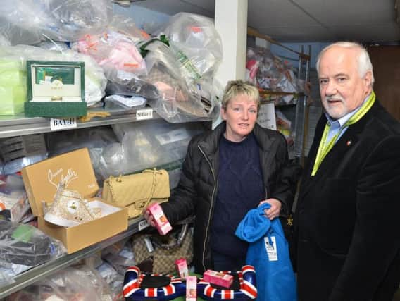 Carol Sampson, operations director at Sports Traider and county councillor Noel Brown begin the clear out of fake and seized goods