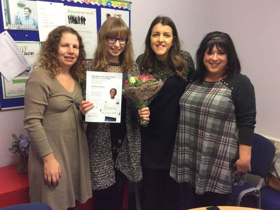 Rebekah Nisbet (second from left) receiving her Volunteer of the Year award from colleagues