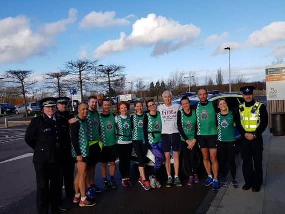 Paul Lander having completed his 100th and final triathlon at the National Memorial Arboretum with Staffordshire Police Chief Constable and the force running team who accompanied him on the last leg