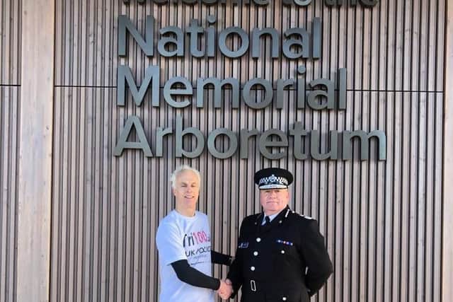Paul Lander at the National Memorial Arboretum with Staffordshire Police Chief Constable Gareth Morgan after completing his 100th and final triathlon