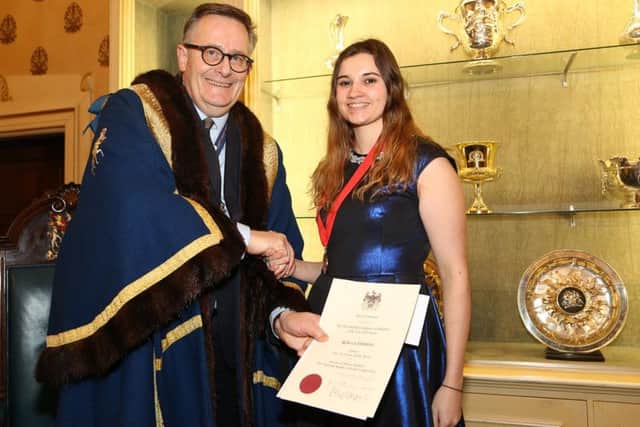 Becky Simmonds receives her award from the Worshipful Company of Saddlers' Prime Warden, James Welch