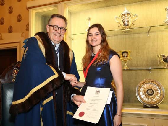 Becky Simmonds receives her award from the Worshipful Company of Saddlers' Prime Warden, James Welch
