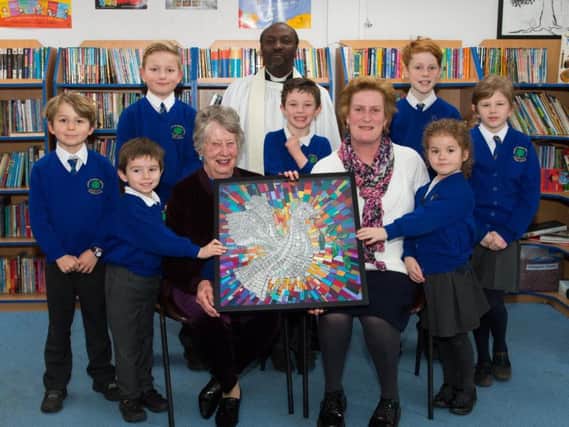 The dedication ceremony of a piece of tapestry art by Elizabeth Brown to Oakley School.
The dedication was conducted by vicar at St Mary Magdalene Church, Shabbington, Rev David Kaboleh.
He is pictured with Oakley School headteacher Caroline Witton (front right) and a representative from each school year.