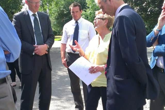 HS2 boss Sir David Higgins speaks to Stoke Mandeville Parish Council chairman Jenny Hunt, in the yellow, during a visit to Old Risborough Road, which will be one of the places affected by the high speed rail line