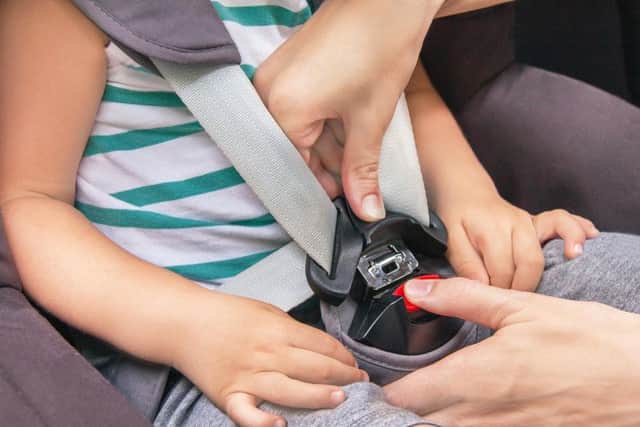 Library image of a child's car seat being fitted