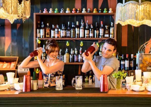 Library image of Rococo Lounge staff serving behind the bar