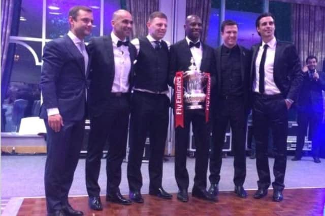 Emmerson Boyce, alongside colleagues from Wigan Athletic, with the FA Cup trophy