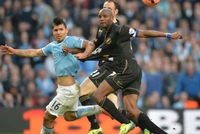 Emmerson Boyce (right) tussles with Manchester City player Sergio Aguero for the ball during the FA Cup final in 2013