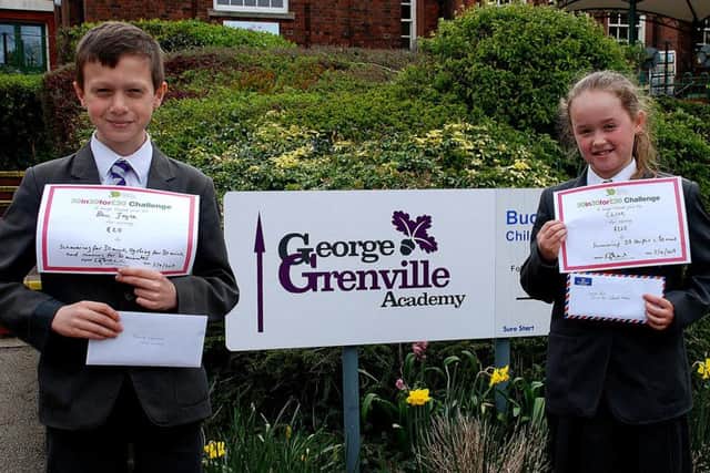 Ben Joyce and Chloe Pool outside George Grenville Academy with their thank you certificates from the Florence Nightingale Hospice
