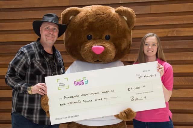 Friars Square Shopping Centre manager Andy Margieson presents a cheque for 1,000 to Sophie Batt from the Florence Nightingale Hospice Charity