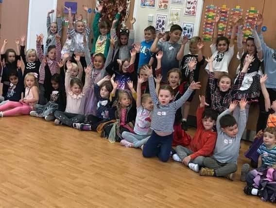 Pupils at a previous Carla Lucas holiday camp with their hands in the air