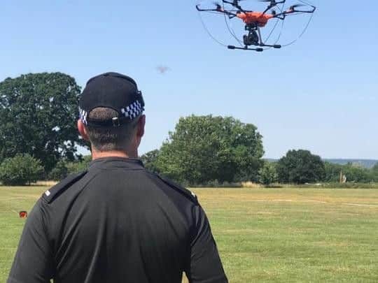 Library image of police officers flying a drone