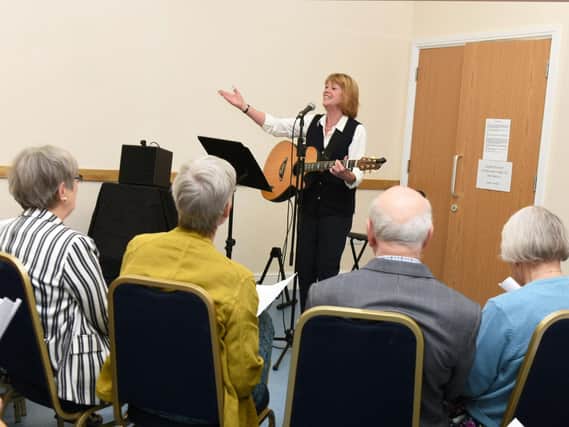 Isla St Clair leads the singing as Cafe Zest celebrates its first birthday