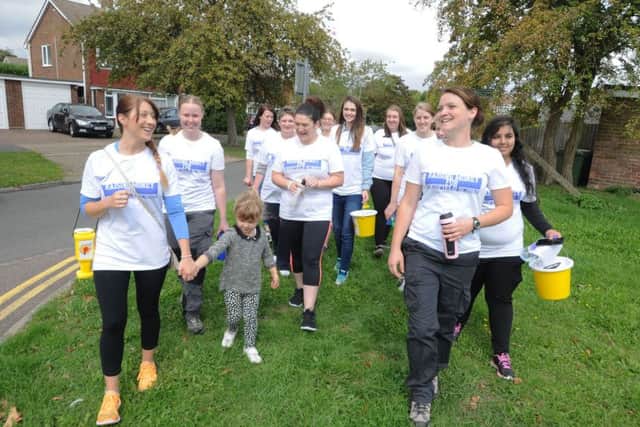 Supporters arrive at Woodfield School, Leverstock Green, after walking from Northchurch to raise funds  to improve the school therapy pool. Sarah Bedford, far left, holds daughter Ella's hand