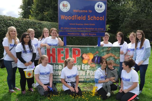 Supporters arrive at Woodfield School, Leverstock Green, after walking from Northchurch to raise funds  to improve the school therapy pool. Sarah Bedford is holding her daughter Ella, aged 4