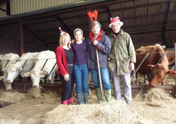 Farmer Geoff Brunt with his wife and their children feeding the cattle on Christmas Day.