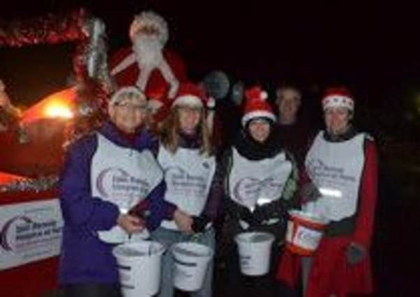 Volunteers out with the Rennie Grove Hospice Care's Santa float, December 2014