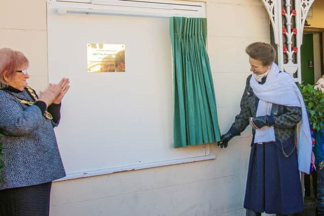 Princess Anne unveils a plaque during her visit to Thame