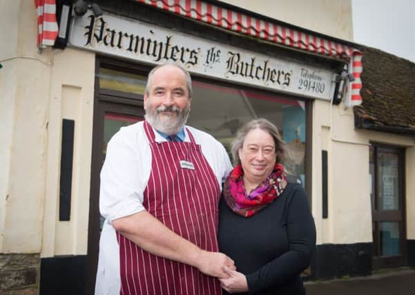 Butcher Simon Parminter - who is retiring - pictured at his shop in Haddenham - pictured with his wife Margot