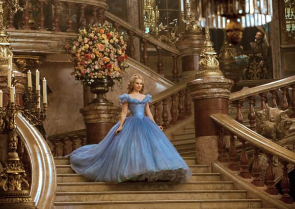 Lily James is Cinderella in  Disney's live-action feature inspired by the classic fairy tale, CINDERELLA, which brings to life the timeless images from Disney's 1950 animated masterpiece as fully-realized characters in a visually dazzling spectacle for a whole new generation.