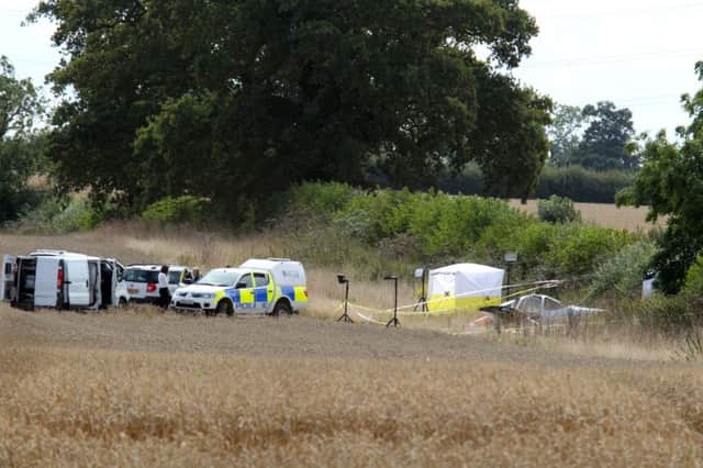 Police and Accident Investigation attend the aftermath of a fatal light aircraft crash in a farmers field near Padbury