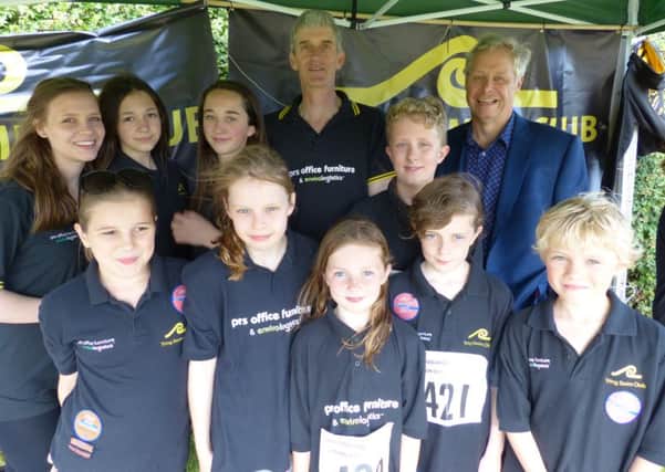 Peter Kemp, MD of PRS Office Furniture, with Tring Swimming Club chairman Mike Billingham and some of the young swimmers from the club