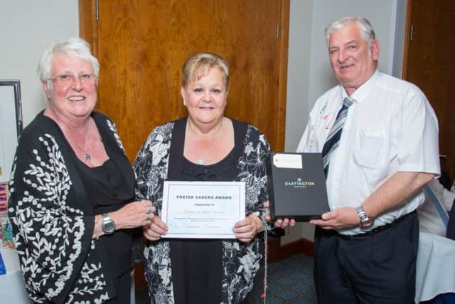 Lin Hazell presents an award for fostering to Juliet and Charlie Cleverdon