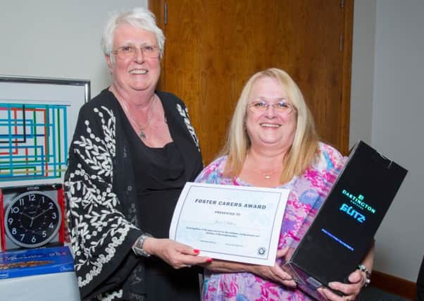 Lin Hazell presents an award for fostering service to June Sutton