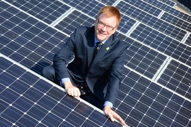 Warren Whyte with the solar panels on the roof of County Hall