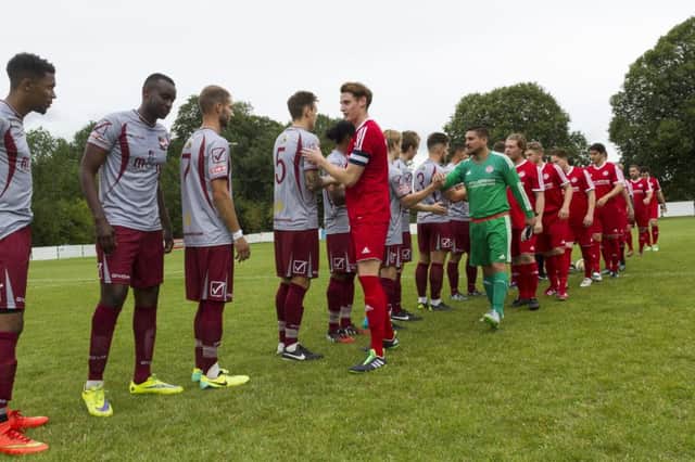 The two teams shake hands prior to kick-off. Pictures by Marc Keinch