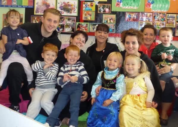 Staff and pupils from Rising Stars Day Care in Winslow celebrate an improved grade from Ofsted
