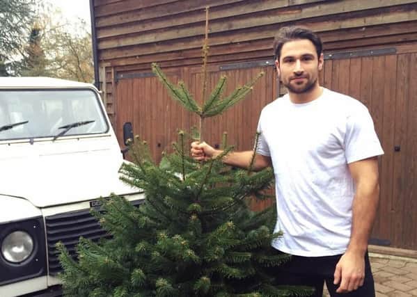 Will Burton with his Defender and one of his popular Christmas trees