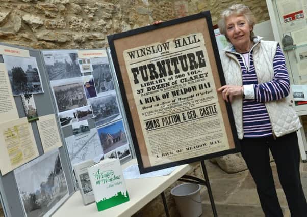 Museum volunteer Lilian McDonald with articles from the exhibition