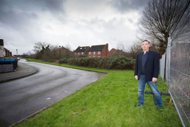 Tony Newman at the entrance of a development near his Hampstead Close home,