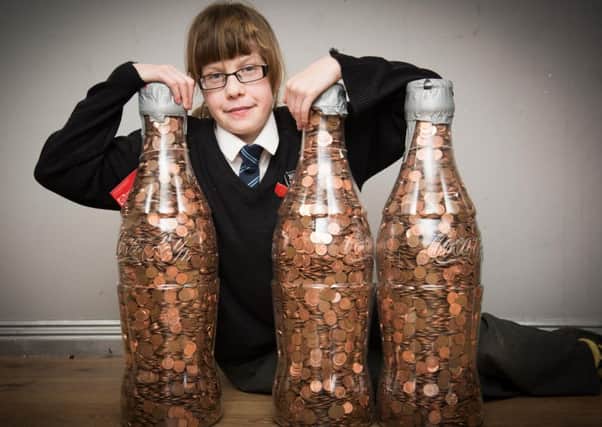 Lucy Collins - pictured with her bottles filled with coins collected for the Florence Nightingale Hospice Charity PNL-160701-213205009