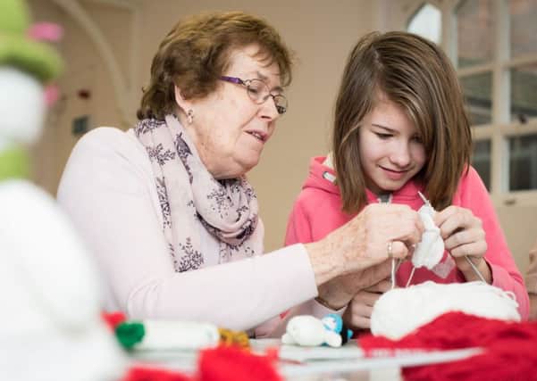 Crafty WI at Bucks County Museum - event showcasing crafts by WI members - pictured is Mavis Allen teaching 11 year old Kathleen Edmonds how to knit