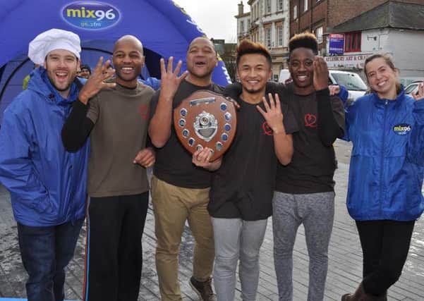 Mix 96 pancake race winners Noodle Nation with the station's breakfast presenters Darren Scott and Katy Brown.